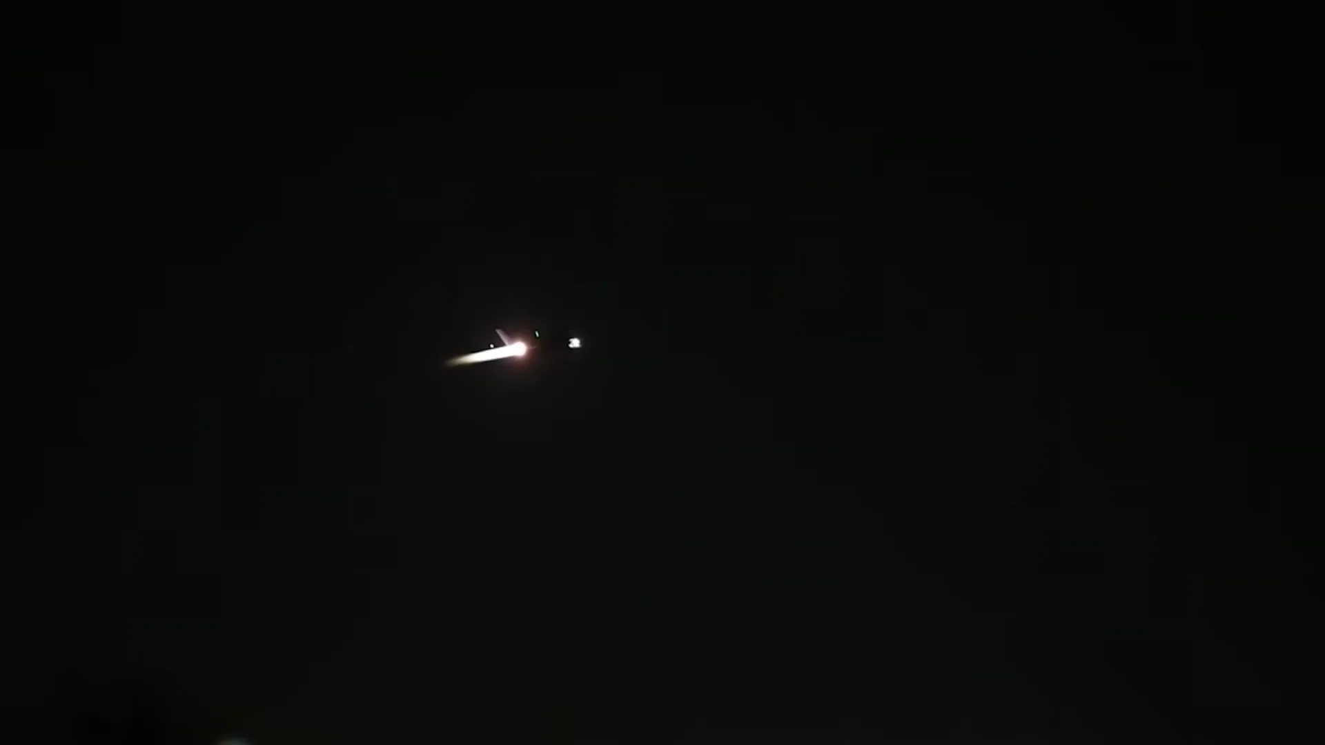 Frame at 3 s: jet climbing with afterburner glow against the night sky.