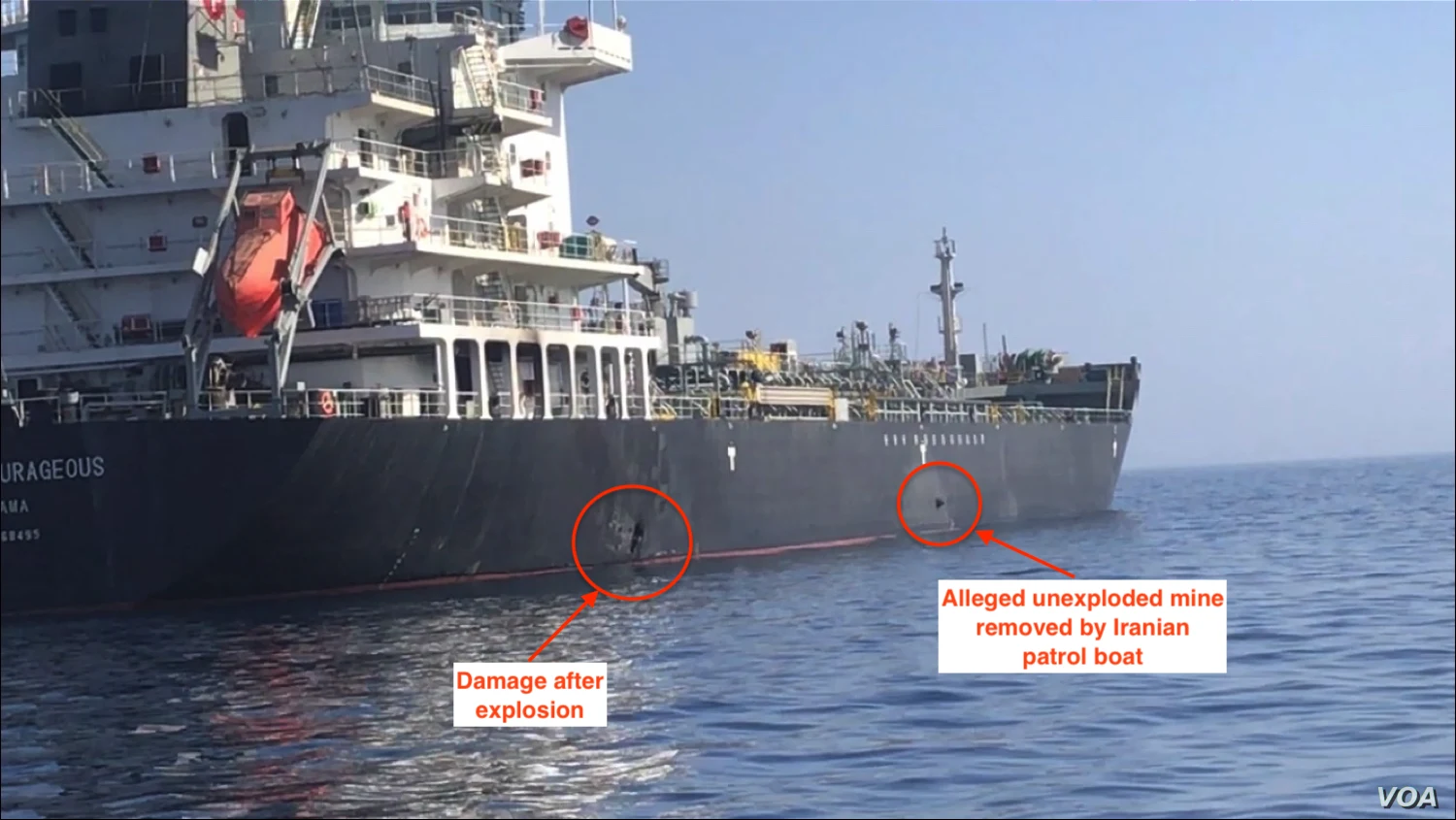 The dark hull of the tanker Kokuka Courageous at sea, with red circles and labels marking a blast hole near the waterline and an object further along the hull that the labels call an alleged unexploded mine.