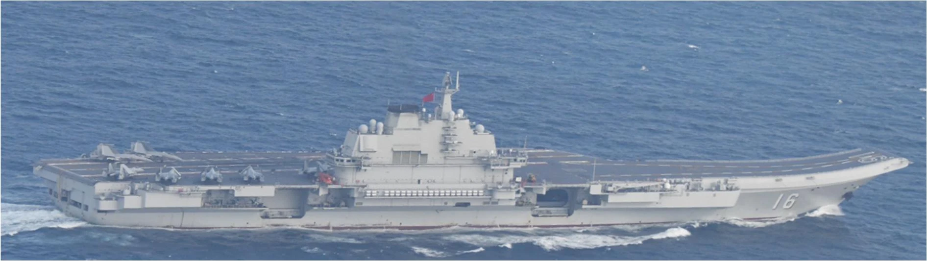 Chinese aircraft carrier Liaoning, hull number 16, under way at sea with aircraft on deck, photographed by Japan's navy.