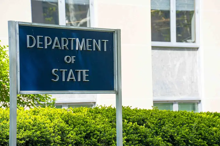 Harry S. Truman Building, headquarters of the U.S. Department of State in Washington, a long pale stone facade with a colonnade.